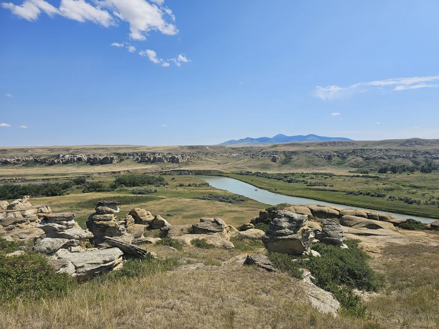 A river winding through an open prairie valley